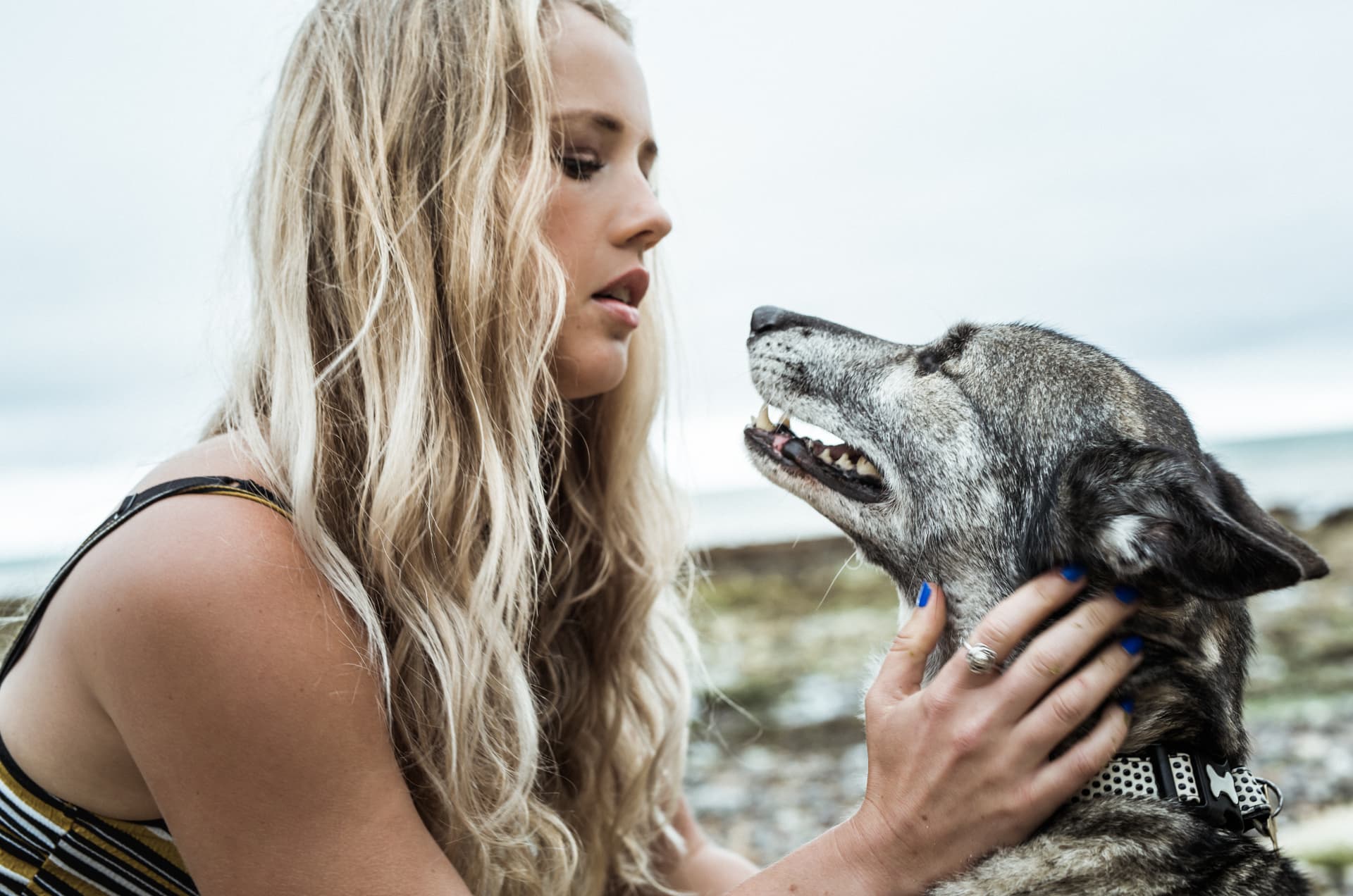 The Lone Wolf handler cradling her dog's neck as they share a quiet moment outdoors